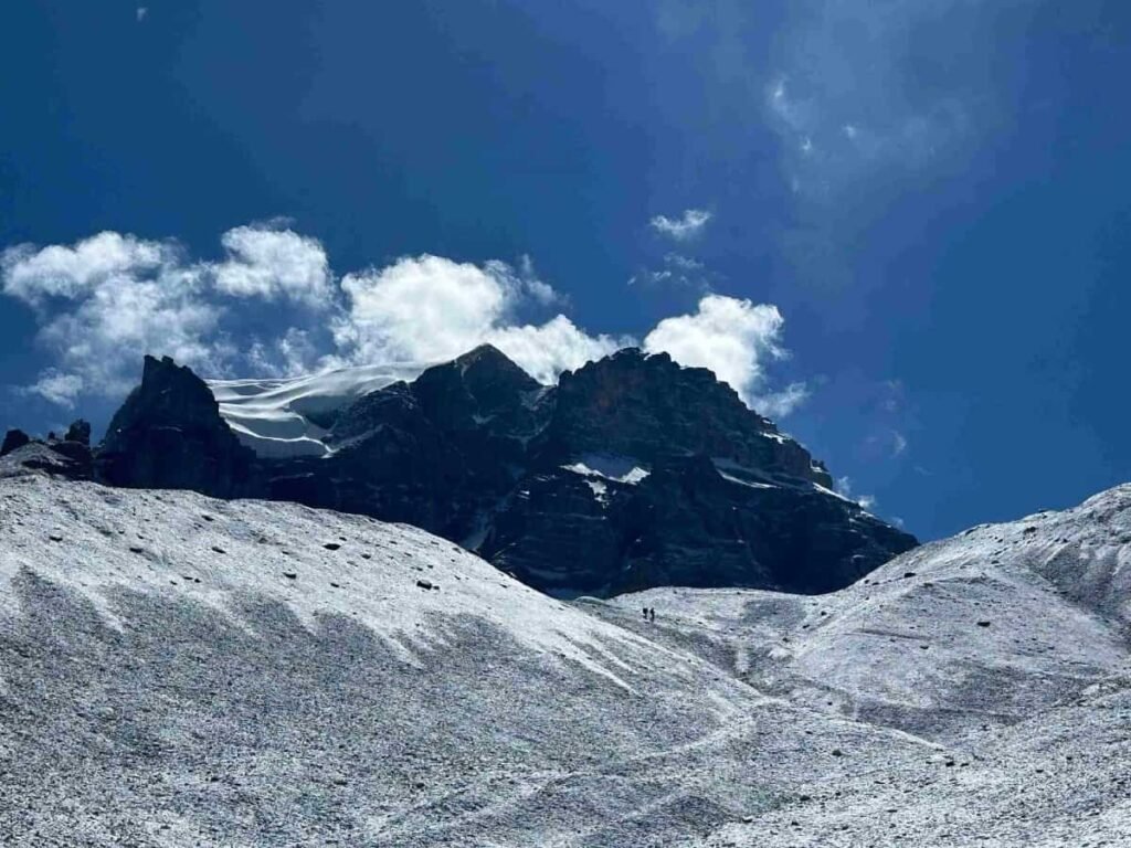Snow-covered mountain trail in the Annapurna region under a clear blue sky